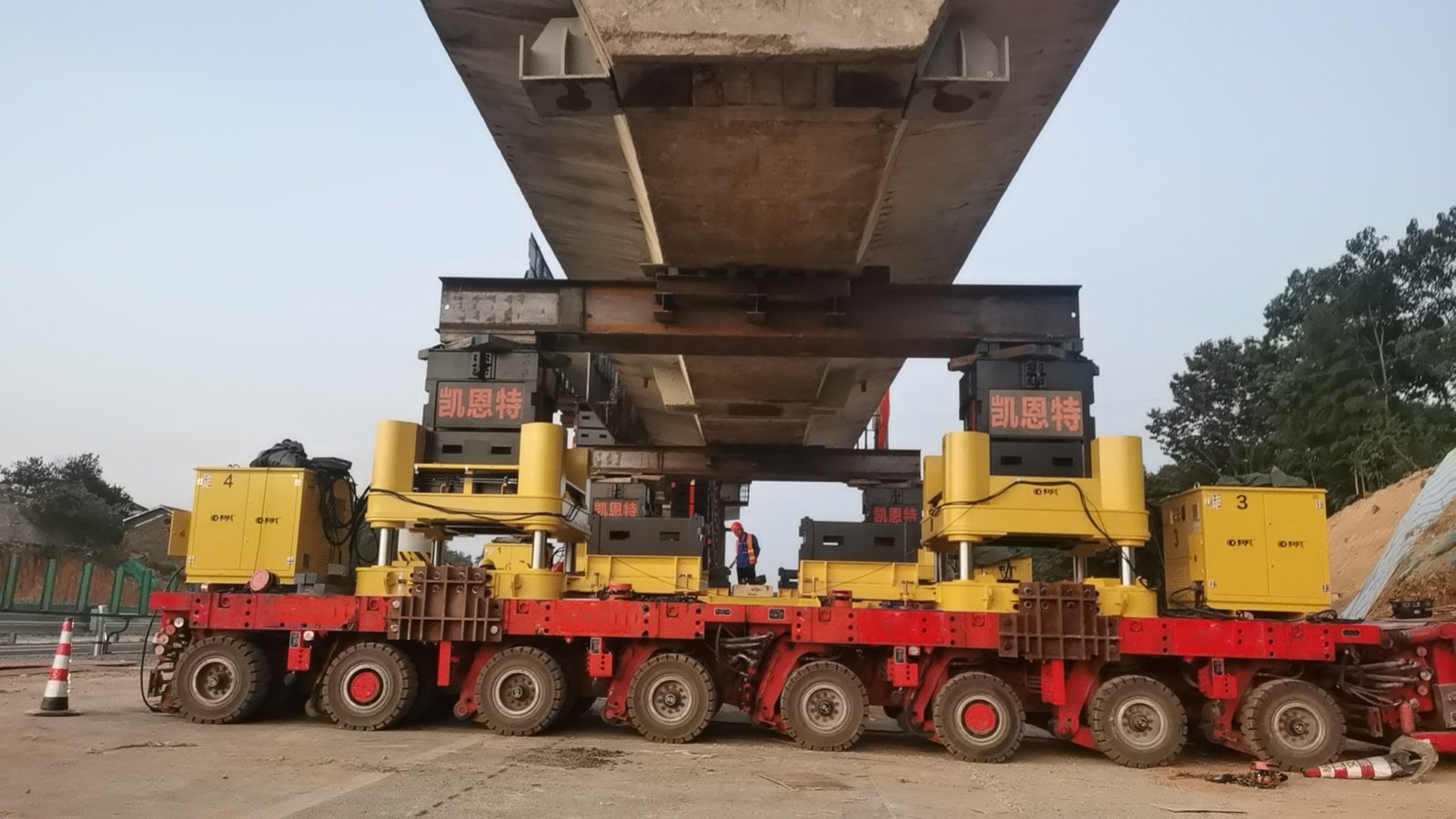 SPMTs Transporting a Bridge Section SPMTs moving a large concrete bridge segment